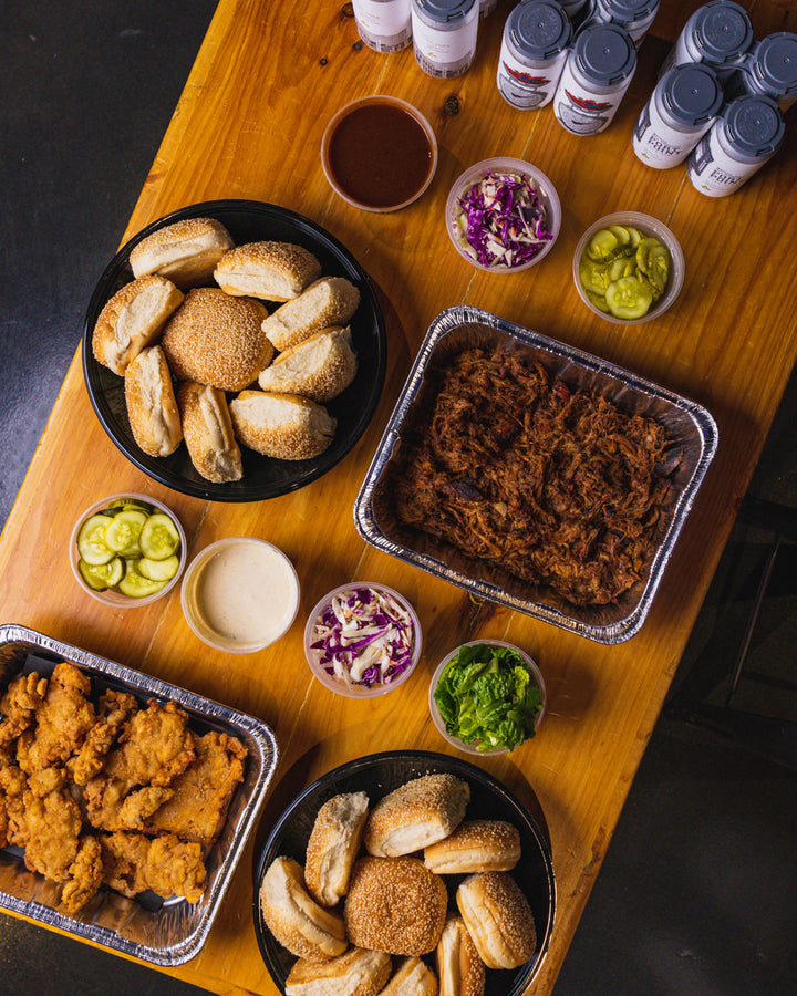 Photo of grouped food for catering events; chicken fingers, pickles, onion, meet and bread