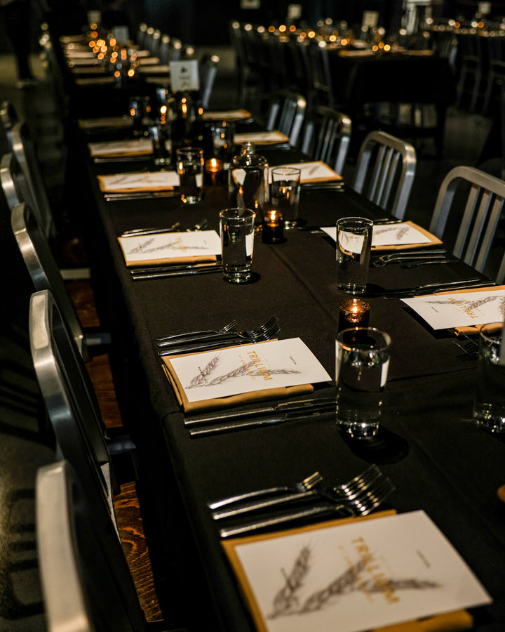 Trillium private events with candle light, silverware, and menu