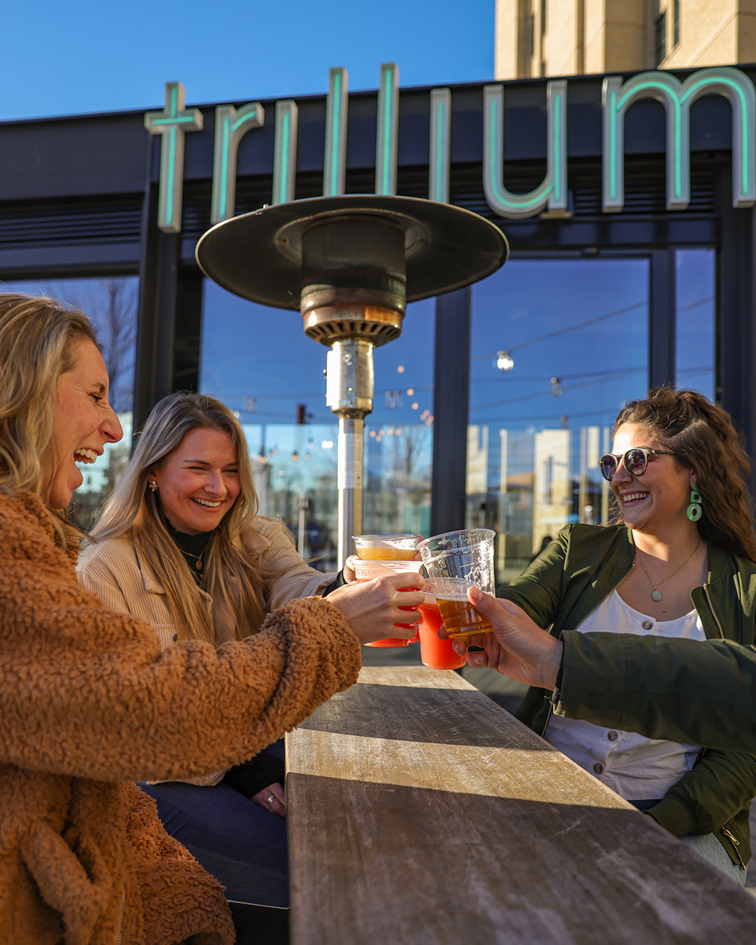 Four guests toasting at Trillium Fenway
