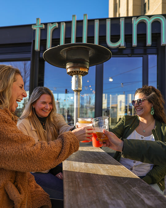 Four guests toasting at Trillium Fenway