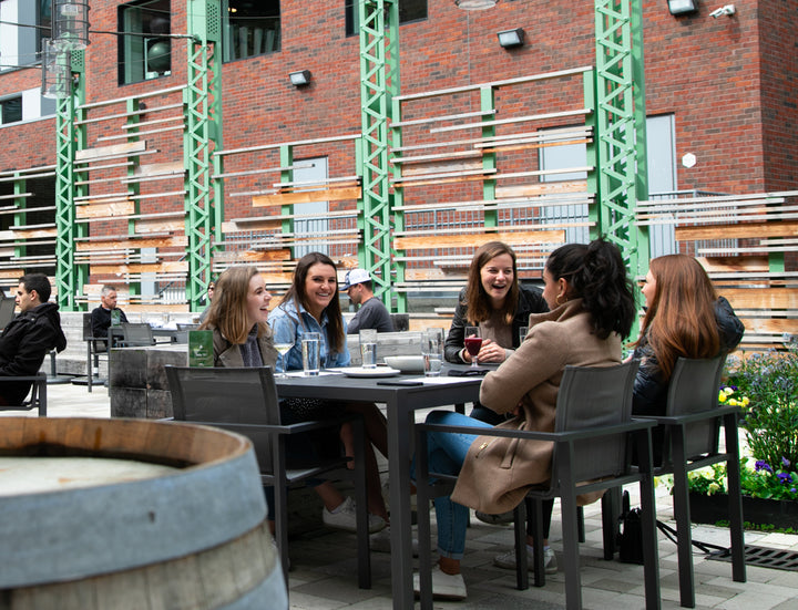 A group of women laughing on the patio at Trillium Fort Point